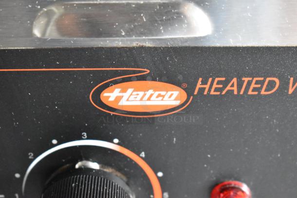 Hatco heated warmer control panel with an adjustable knob, showing settings 1-4, and a branded logo in orange.