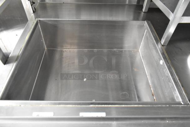 Stainless steel food trailer interior, clean and ready for use. Durable construction ideal for commercial kitchen setup.