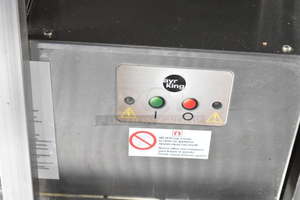 Food trailer appliance with AyrKing controls. Features green and red buttons, safety warnings, stainless steel surface.