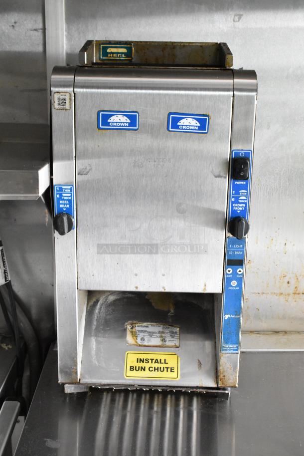 Fully equipped food trailer appliance, Antunes bun toaster with adjustable settings, visible wear, and "Install Bun Chute" label.