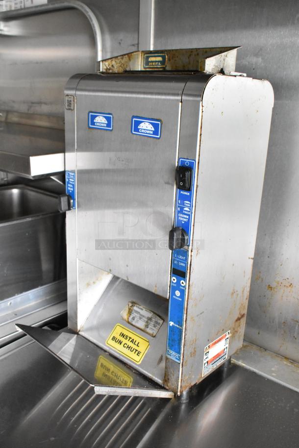 Food trailer appliance, Crown brand, stainless steel construction. Visible wear, bun chute installation label present.