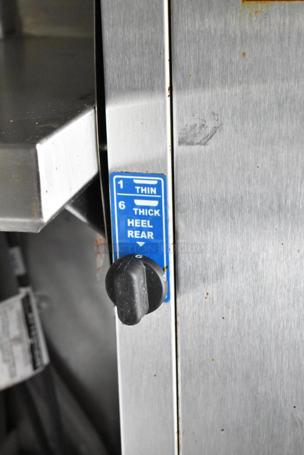 Stainless steel food trailer fixture with adjustable dial showing settings 1-6 for thickness; labels for "Thin" and "Thick Heel Rear" visible.