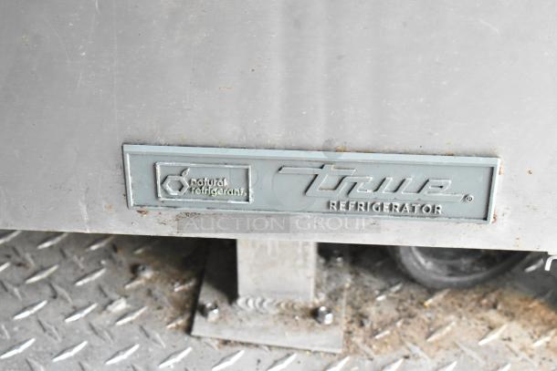 True Refrigerator panel with "natural refrigerant" marking on stainless steel food trailer interior. Ideal for starting food business.