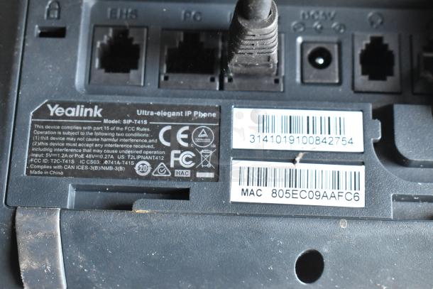 Yealink IP phone model SIP-T41S label with FCC compliance and MAC address visible.