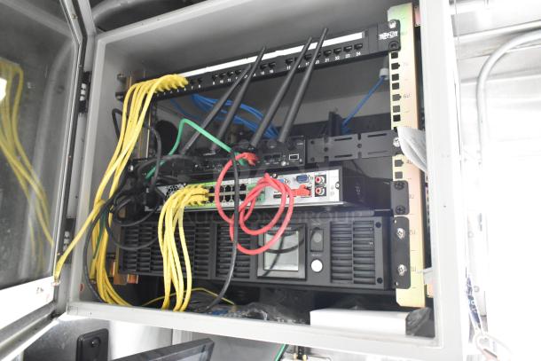 Fully equipped food trailer interior showing network equipment and wiring, indicating advanced setup for immediate use.