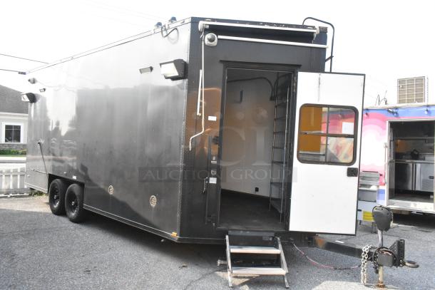 Black SDG Trailers trailer with dual axles, open side door, and exterior lighting. Good condition, ready for appliances/fixtures.