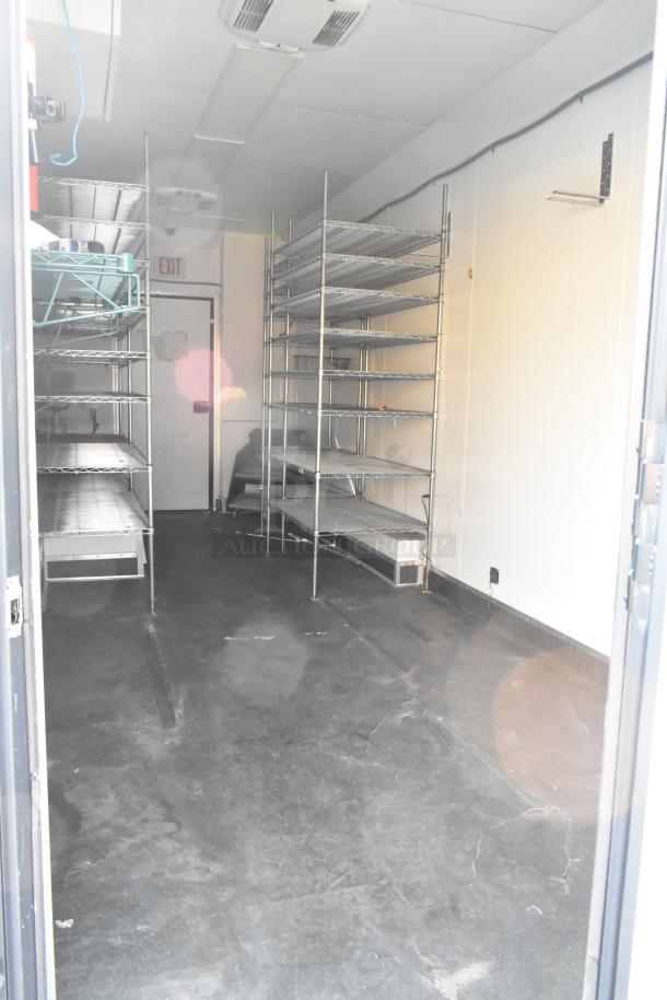 SDG Trailers industrial trailer interior with metal shelving. Clean condition, suitable for storage or appliance setup.