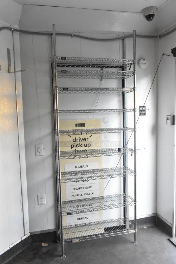 SDG Trailers Trailer with a metal shelving unit, seven adjustable wire shelves, used for appliance/fixture storage.
