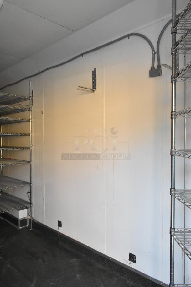 SDG Trailers interior with metal shelving, wiring, and utility fixtures. Sturdy design and clean condition.