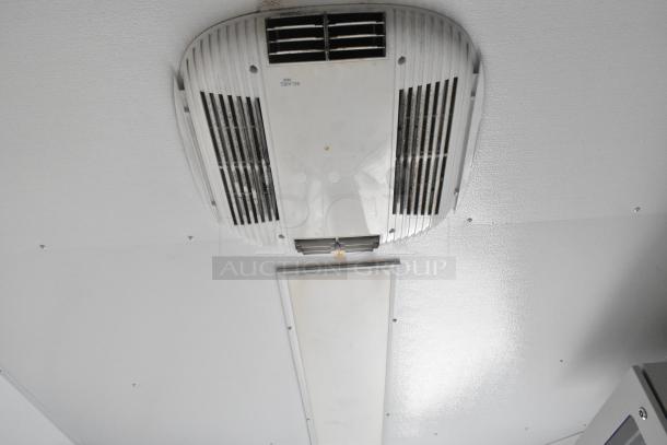 Ceiling-mounted air vent in SDG Trailers Trailer, featuring grill design and compact form, used for ventilation purposes.