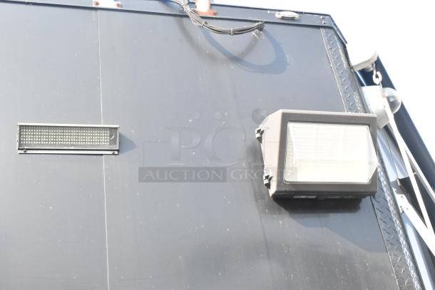 SDG Trailers trailer wall with mounted light fixture and wiring, showcasing durable construction and outdoor utility.
