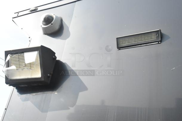 SDG Trailers exterior view with security camera and lighting fixture; clean surface with minimal wear.