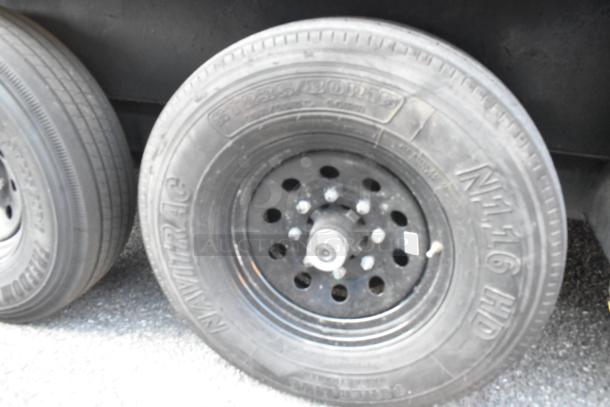SDG Trailers tire with NAVITRAC NH 116 HD markings, showing a black steel rim and visible specifications.