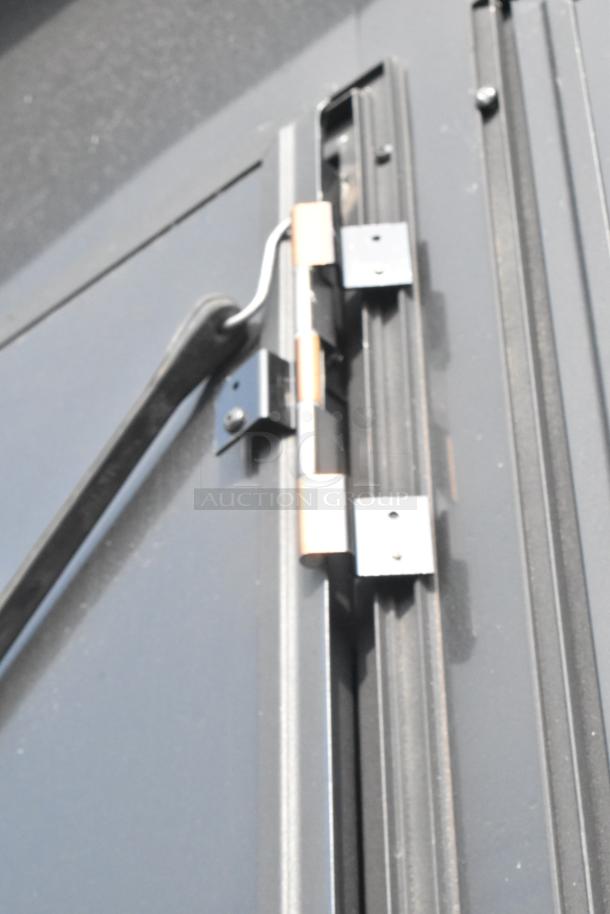 Close-up of SDG Trailers trailer hinge mechanism, showcasing metal construction and mounting hardware.
