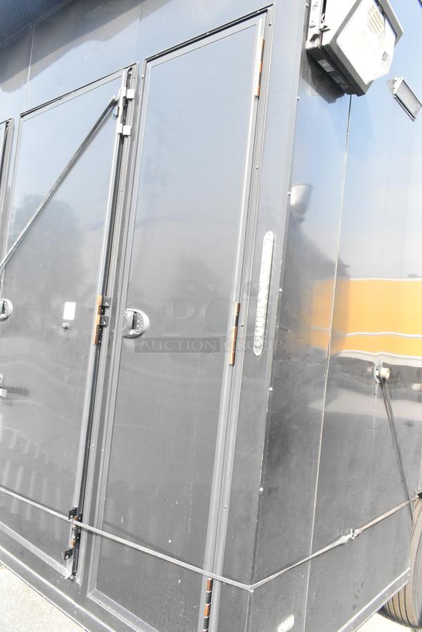 SDG Trailers black trailer with side doors, exterior light, and visible hinges. Clean condition, suitable for appliances/fixtures.