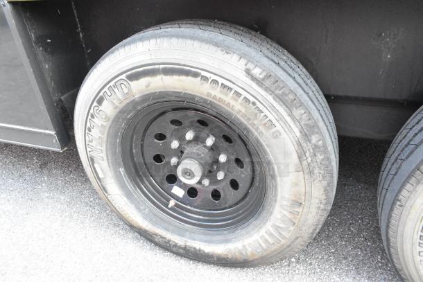 SDG Trailers tire, Power King radial trailer, black steel rim, visible wear, size 7.50x16. SQN916-HD marking.