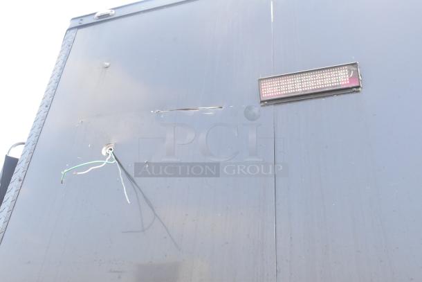 Black SDG Trailers trailer side view with visible scuffs and exposed wiring. No visible labels or markings.
