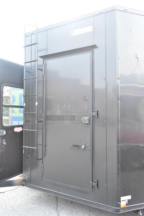 SDG Trailers trailer, black with ladder and diamond plate accents. Visible phone number on label, sturdy construction.