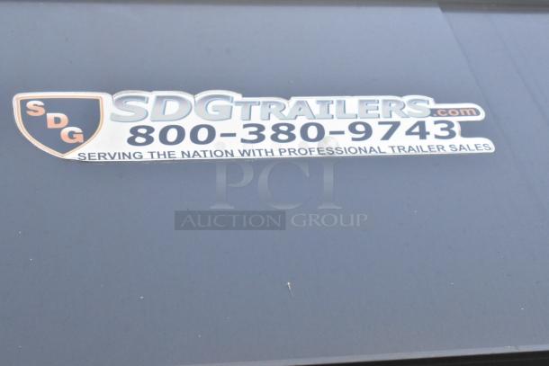 Sticker on SDG Trailers trailer, showing logo, phone number, and sales slogan. 
