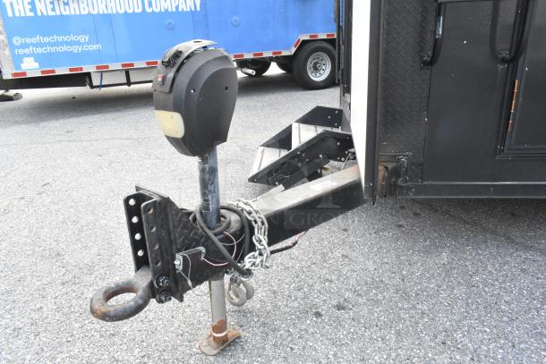 SDG Trailers trailer hitch detail, featuring rust-resistant metal, sturdy chains, and a secure locking mechanism.