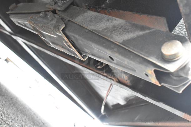 SDG Trailers trailer frame underside, showing a metal bracket with signs of rust, indicating use and wear.