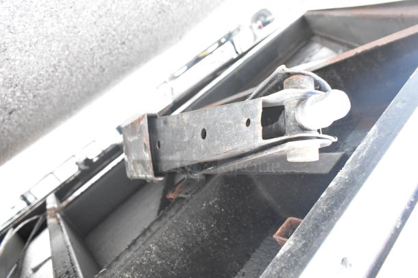 SDG Trailers Trailer, detailed view of suspension component, metal construction, visible rust and wear marks, structural detail.