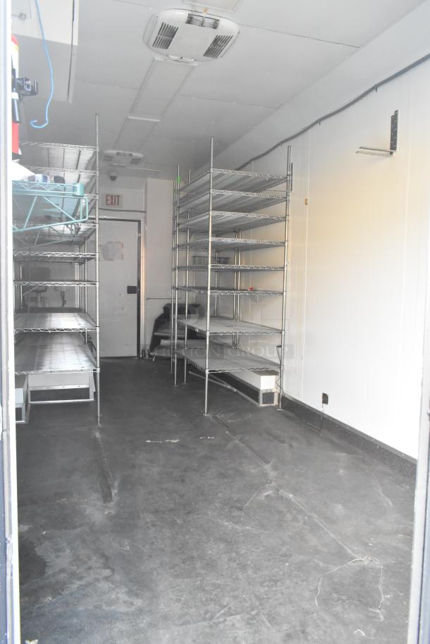 SDG Trailers storage trailer interior; features metal shelving units and visible AC vents, suitable for appliances or fixtures.
