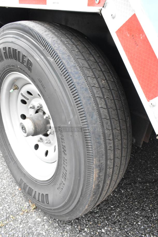 Wheel of a fully outfitted Reef food trailer, featuring a durable tubeless all-steel radial tire.
