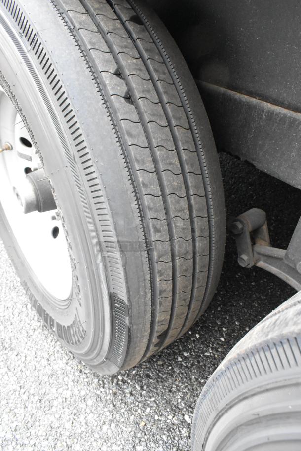 Close-up image of trailer tire showing tread pattern and condition, indicating road readiness and durability.