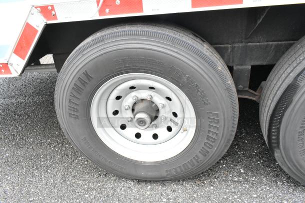 Close-up of a Dutymax tire on a food trailer, featuring ST235/80R16 markings, indicating size and type.