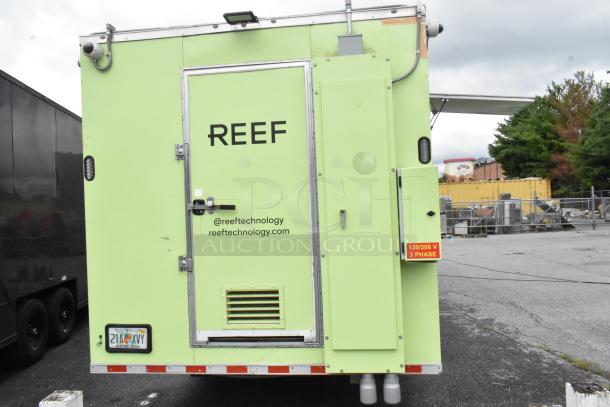 Fully equipped Reef food trailer, green exterior, ready for use. Features include a rear door, ventilation, and power connections.