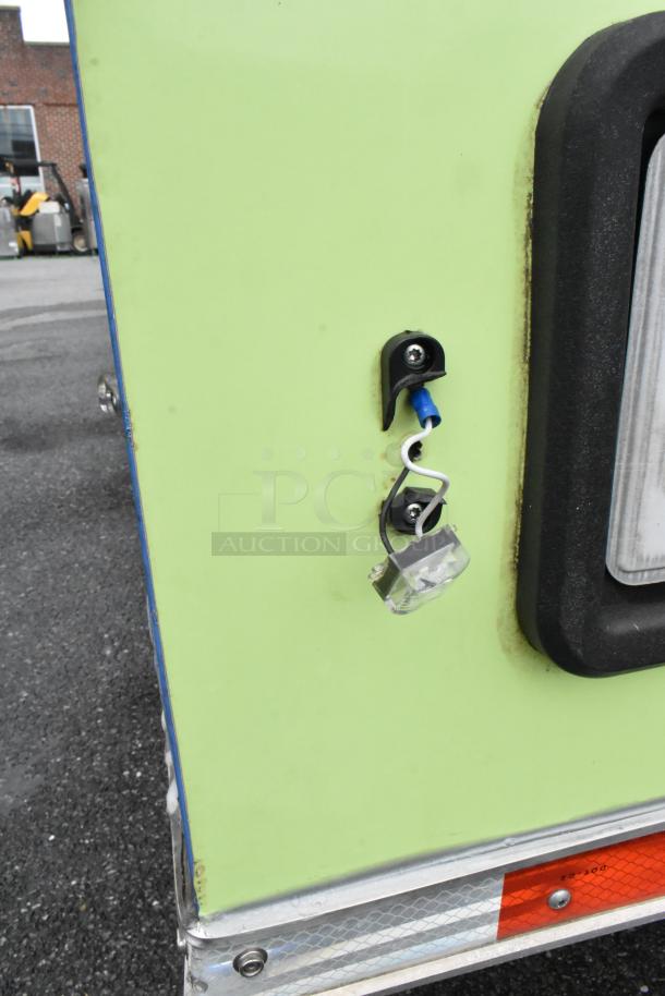 Green reef food trailer corner with visible wiring and black fixture, ready for opening day. Check description for appliance specifics.