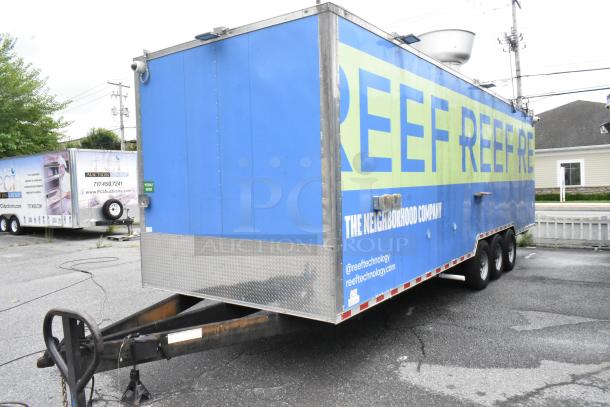 Fully outfitted Reef food trailer, blue exterior with branding, equipped for operation. Includes appliances and fixtures.
