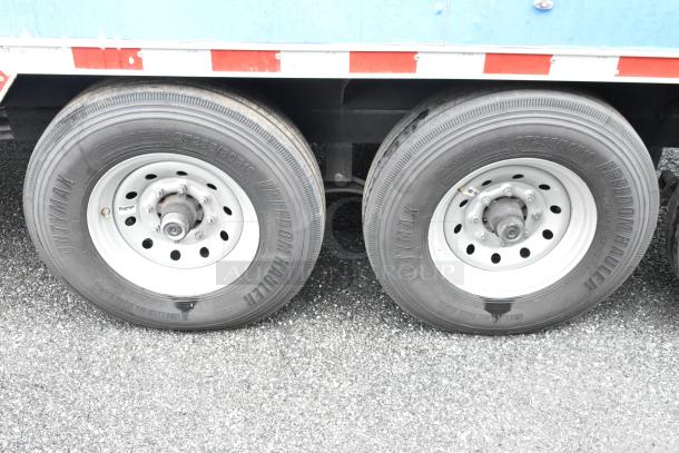 Dual wheel setup of a food trailer featuring Freedom Hauler tires, model ST235/80R16, ready for immediate use.
