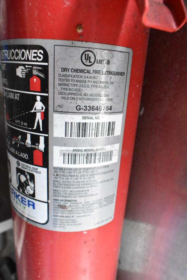 Red fire extinguisher in a food trailer, UL listed, dry chemical type, classification 3-A:40-B:C, Serial No. G-33645754.