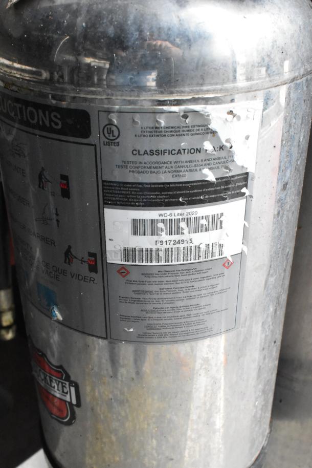 Wet chemical fire extinguisher with label indicating 6-liter capacity, classification K, UL listed, Buckeye brand.