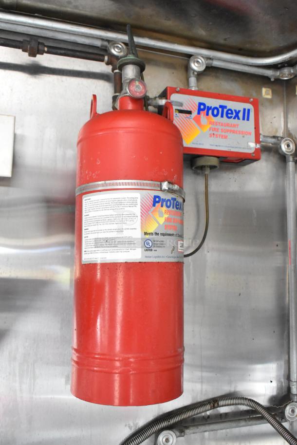 Red ProTex II fire suppression system in food trailer, features labeling for restaurant use compliance.