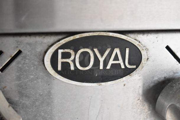 Close-up of a "Royal" branded metal appliance label on a food trailer. The surface shows signs of use.