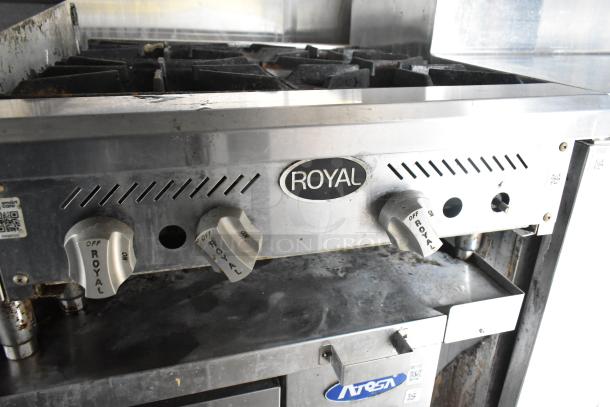 Royal stove unit in a food trailer. Visible knobs labeled "Royal." Slight wear suggests moderate use.