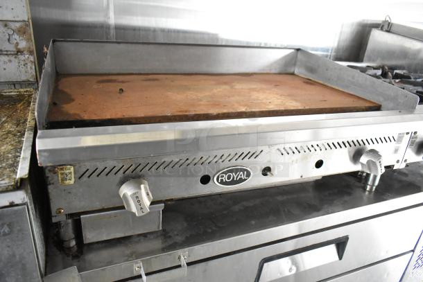 Royal commercial griddle in food trailer, steel construction, integrated control knobs, lightly used condition.