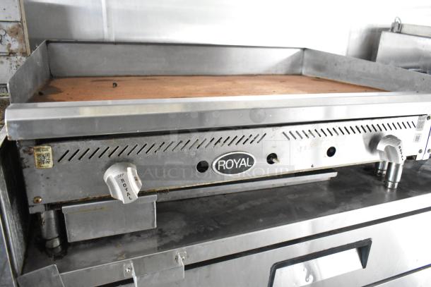 Stainless steel Royal griddle in food trailer, dual control knobs, slightly used condition, sturdy build for commercial use.
