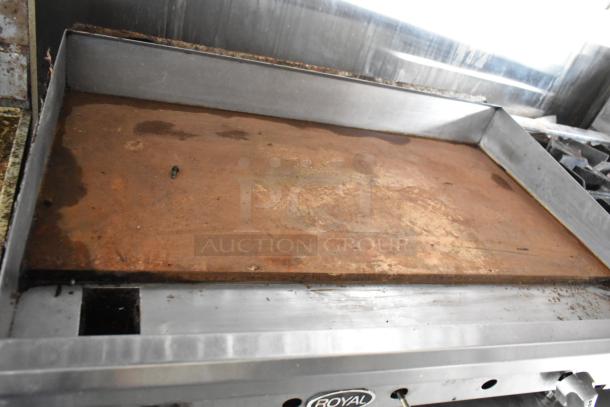 Professional-grade griddle with visible wear, part of a fully outfitted food trailer. Features a Royal brand nameplate.