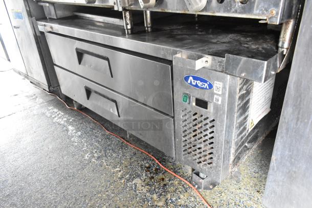 Alt text: A fully outfitted food trailer with stainless steel Atosa refrigeration unit and storage drawers, ready for use.