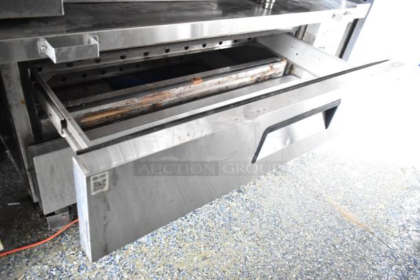 Stainless steel food trailer appliance drawer, shows wear; part of a fully outfitted More Than A Dream food trailer.