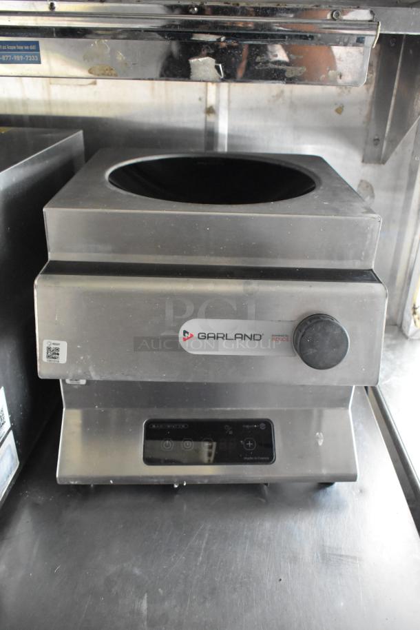 Garland induction cooktop in stainless steel, featuring a control knob and digital display. Appears in good condition.