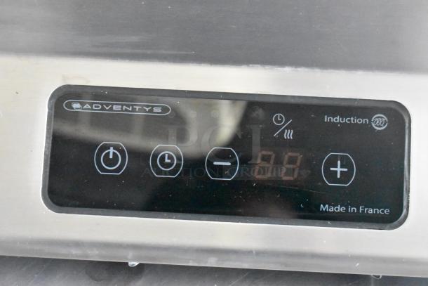 Induction cooktop control panel by Adventys, featuring power, timer, and temperature settings. Made in France.