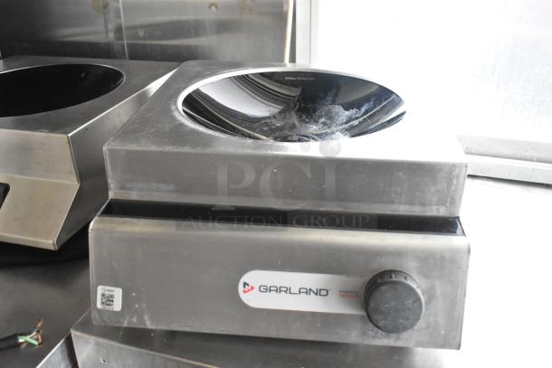 Garland stainless steel induction cooktop in food trailer, features rotary knob, sleek design, suitable for professional use.