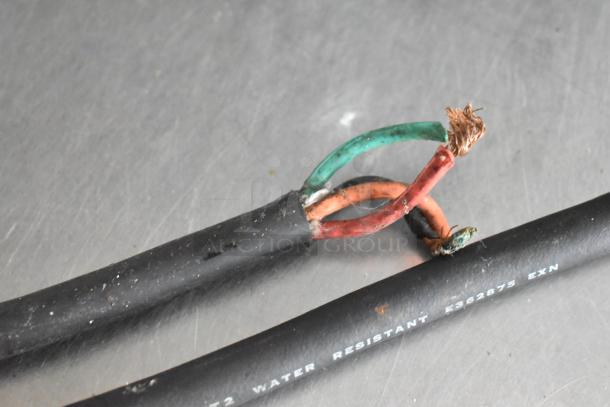 Damaged electrical cable with exposed copper wires, black insulation. Marking reads: "E362875 EXN" and "WATER RESISTANT."