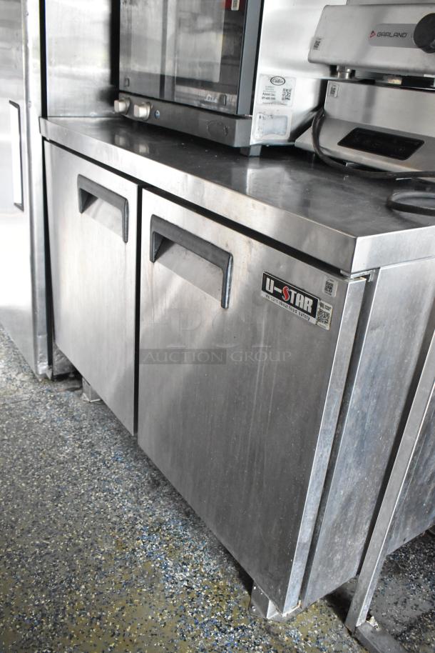 U-Star stainless steel commercial fridge in food trailer, showing durable design and Garland appliance above.