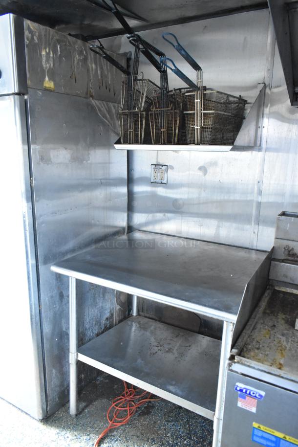 Food trailer interior with stainless steel counter, fryer baskets, and electrical outlets. Used condition, ready for business.